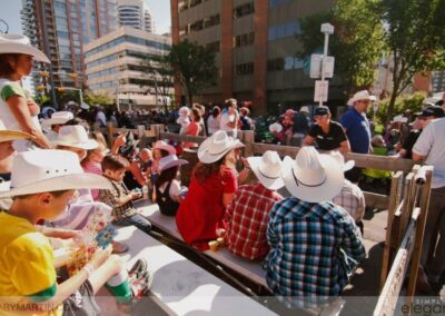 Calgary Stampede events planning services - group watches parade passing by