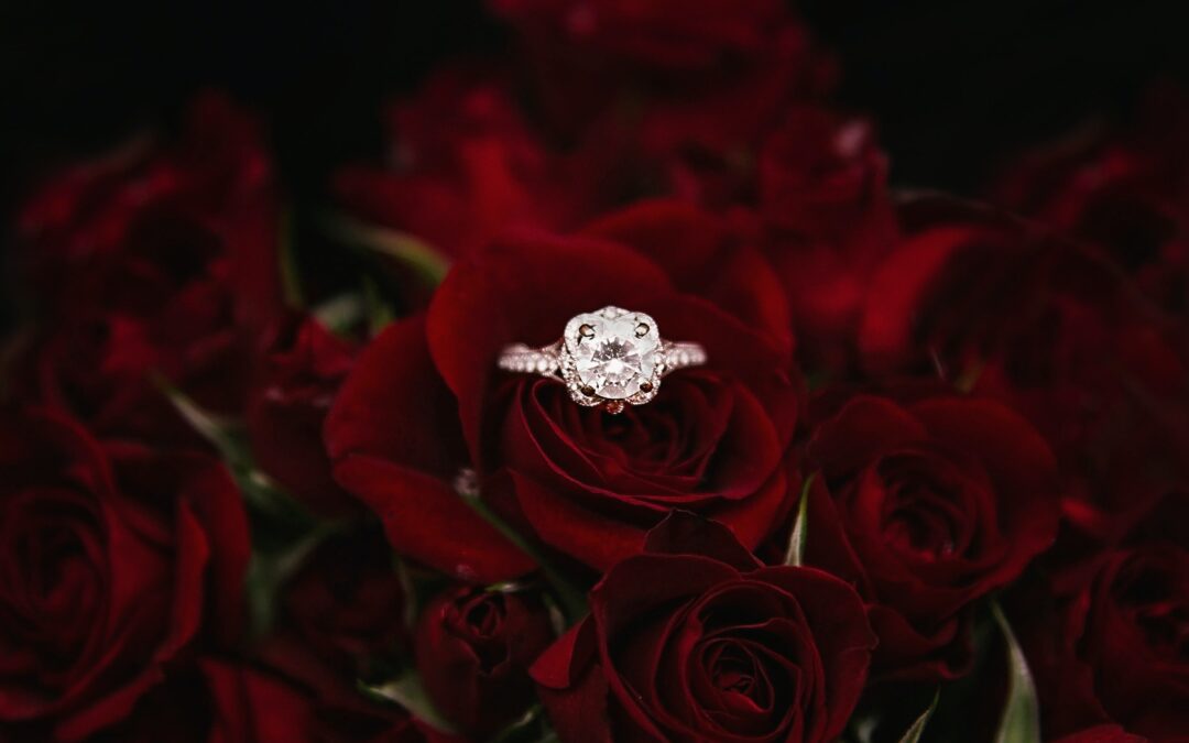 Engagement ring on red roses